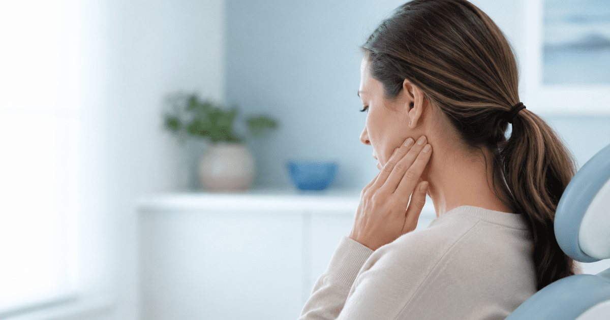 Dr. Benton evaluating a patient's jaw, Restorative Wellness Center, Rogers AR.